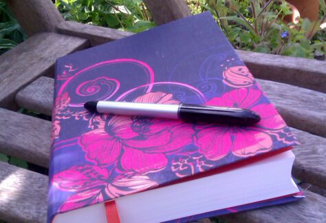 journal and pen on bench