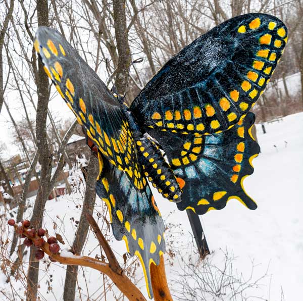 swallowtail butterfly sculpture in snowy scene